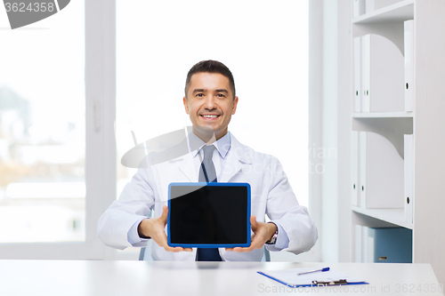 Image of smiling male doctor showing tablet pc blank screen