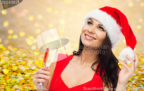 Image of beautiful woman in santa hat with champagne glass