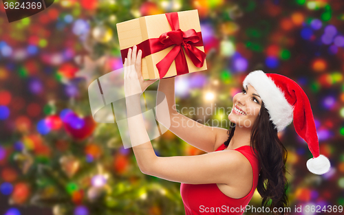 Image of beautiful sexy woman in santa hat with gift box