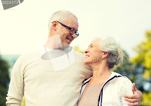 Image of senior couple hugging in city park