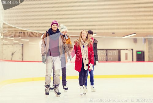 Image of happy friends on skating rink