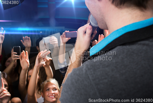 Image of close up of happy people at concert in night club