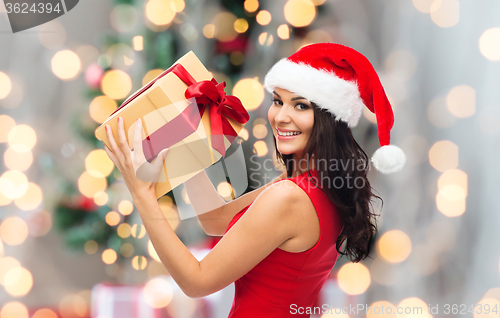 Image of beautiful sexy woman in santa hat with gift box