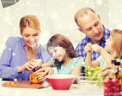 Image of happy family with two kids making dinner at home