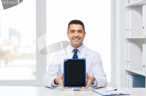 Image of smiling male doctor showing tablet pc blank screen