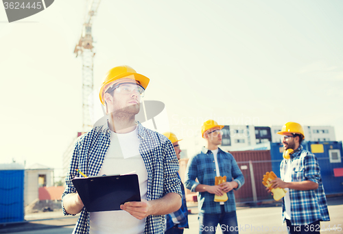 Image of group of builders in hardhats outdoors