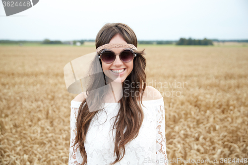 Image of smiling young hippie woman on cereal field