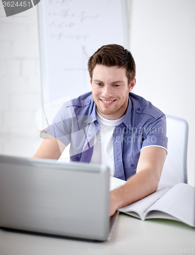 Image of high school student with laptop in classroom