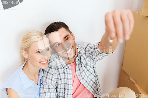 Image of couple with key and boxes moving to new home