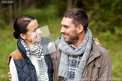 Image of happy couple hugging at camp in woods