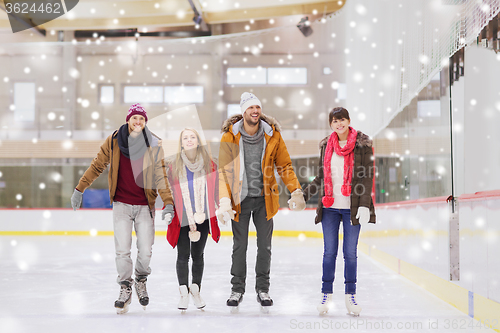 Image of happy friends on skating rink