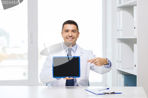 Image of smiling male doctor showing tablet pc blank screen