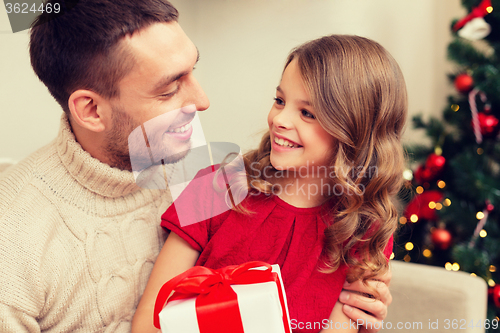 Image of smiling father and daughter looking at each other