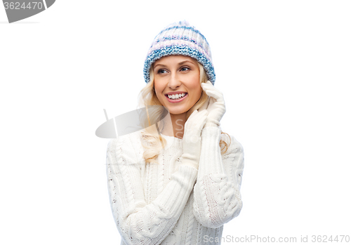 Image of smiling young woman in winter hat and sweater