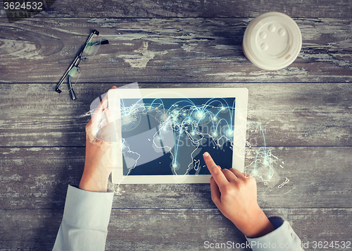 Image of close up of hands with tablet pc and network