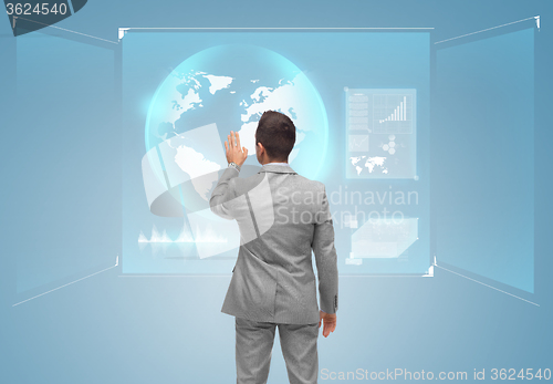 Image of businessman touching virtual screen with globe