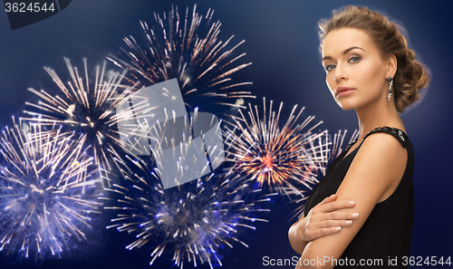 Image of beautiful woman wearing earrings over firework