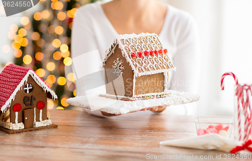 Image of close up of woman showing gingerbread house