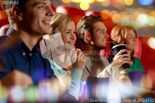 Image of happy friends watching movie in theater