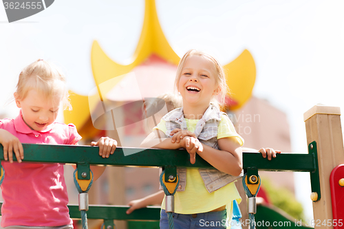 Image of happy little girls on children playground