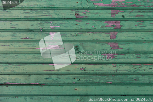 Image of old wooden boards painted in green background