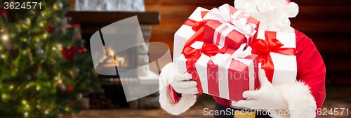 Image of man in costume of santa claus with gift boxes