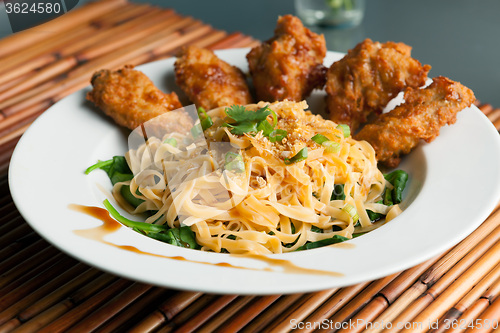 Image of Chicken Wings with Noodles and Spinach