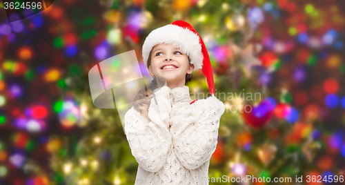 Image of dreaming girl in santa helper hat