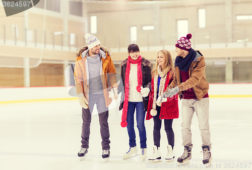 Image of happy friends on skating rink