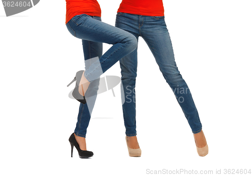 Image of close up of two women legs in jeans