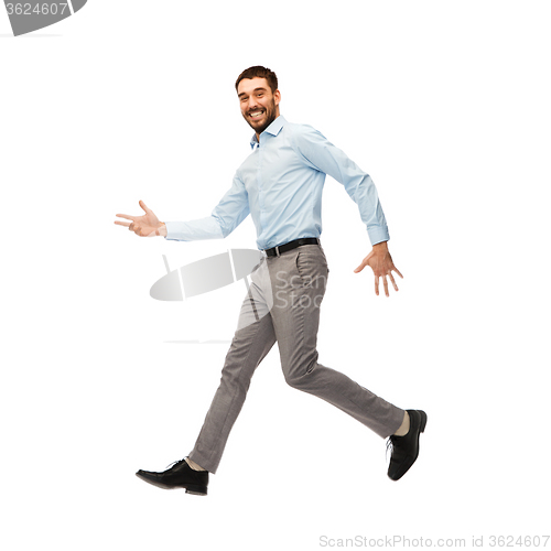 Image of smiling young man jumping in air