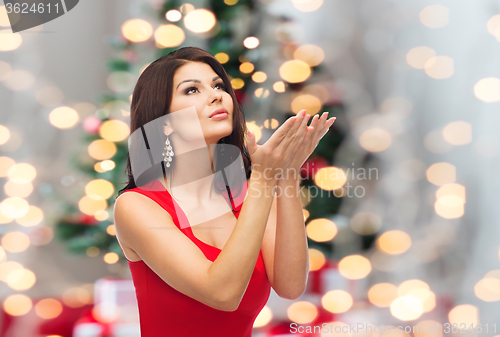 Image of beautiful woman making christmas wish over lights