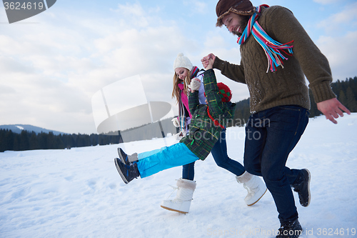 Image of happy family playing together in snow at winter