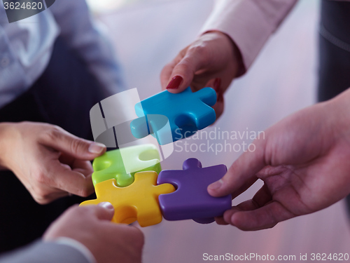 Image of business people group assembling jigsaw puzzle