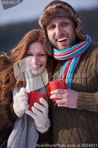 Image of couple drink warm tea at winter