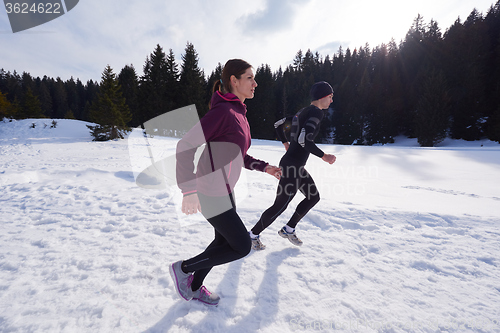 Image of couple jogging outside on snow