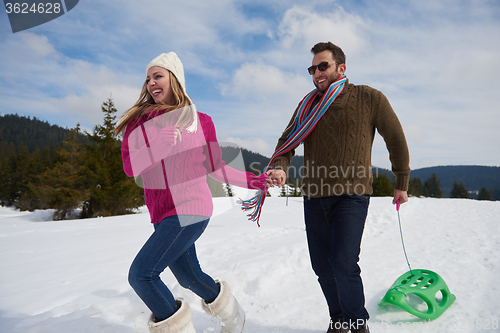 Image of happy young couple having fun on fresh show on winter vacation