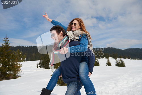 Image of happy young couple having fun on fresh show on winter vacation