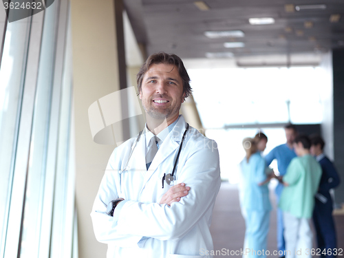 Image of group of medical staff at hospital, doctor in front of team