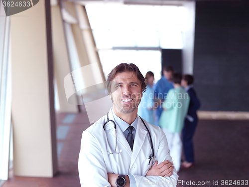 Image of group of medical staff at hospital, doctor in front of team