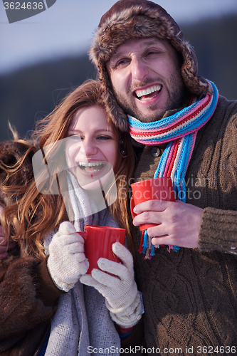 Image of couple drink warm tea at winter