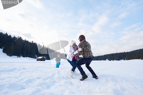 Image of happy family playing together in snow at winter