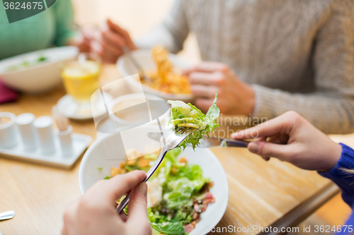 Image of close up friends having dinner at restaurant