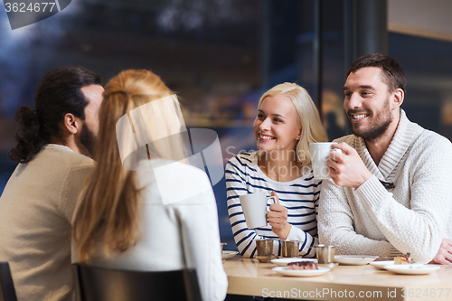 Image of happy friends meeting and drinking tea or coffee