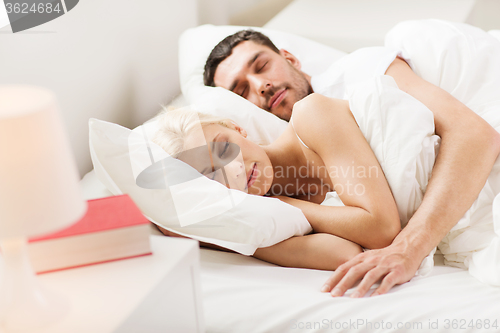 Image of happy couple sleeping in bed at home