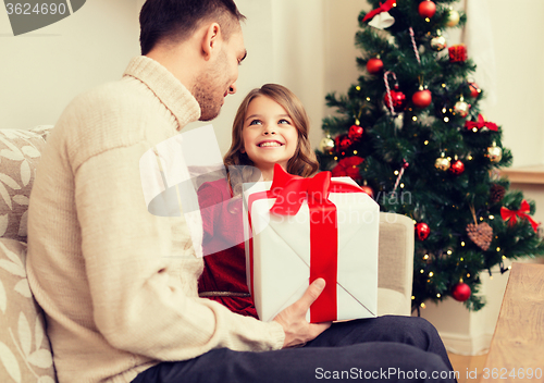 Image of smiling father and daughter looking at each other