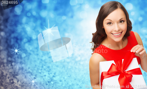 Image of smiling woman in red dress with gift box