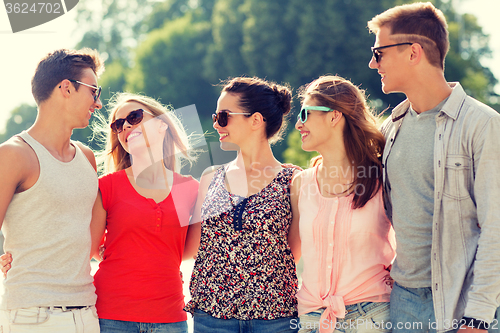 Image of group of smiling friends in city