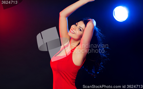 Image of beautiful sexy woman in red dancing at nightclub