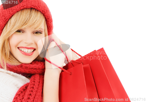 Image of smiling young woman with shopping bags